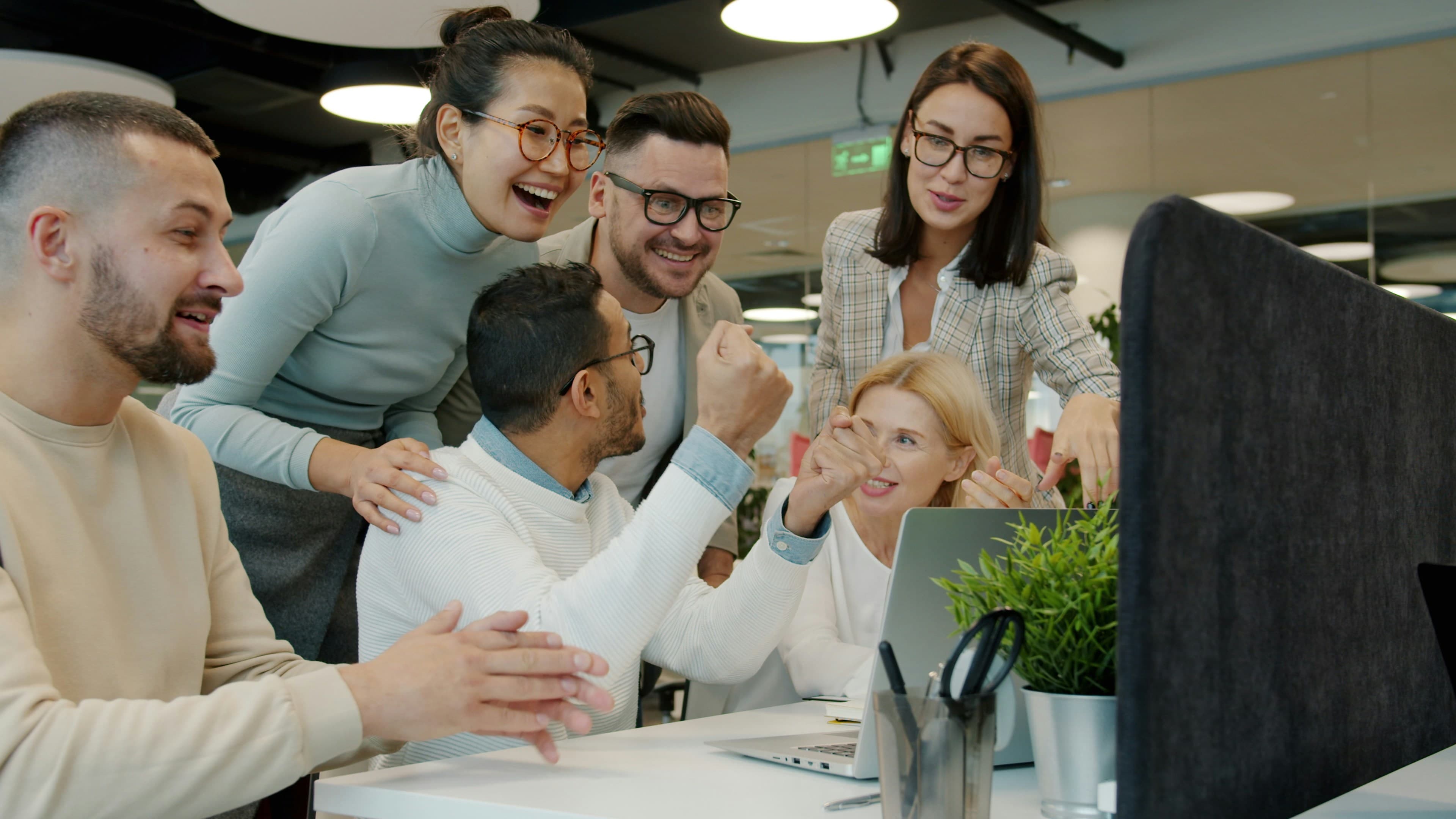 Team celebrating a win together in the office